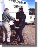 Photo of Sergeant Cordia assisting Sergeant Clark with the SRS-5 Suit