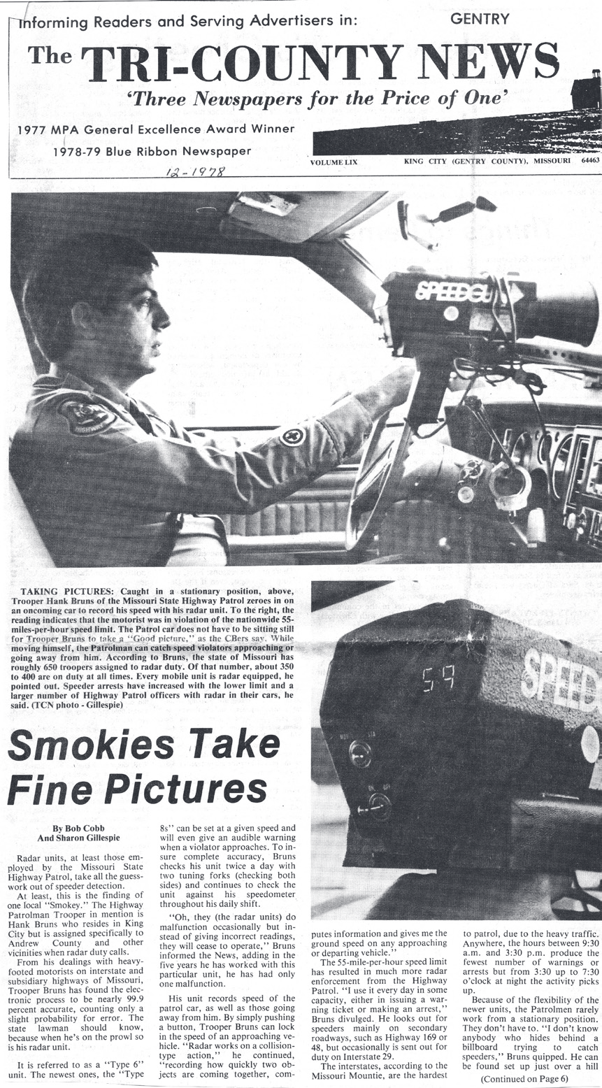 Tri-County News newspaper clipping featuring a photo of Cpl. Bruns operating radar equipment inside a patrol vehicle.